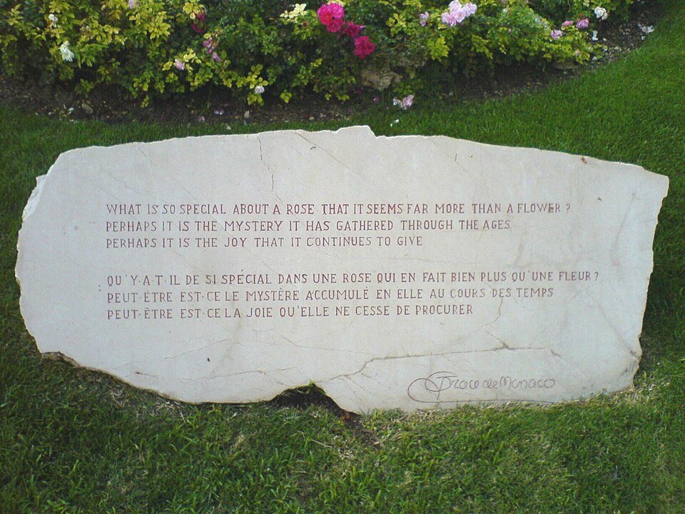 A stone in the rose garden carved with a quotation about roses
